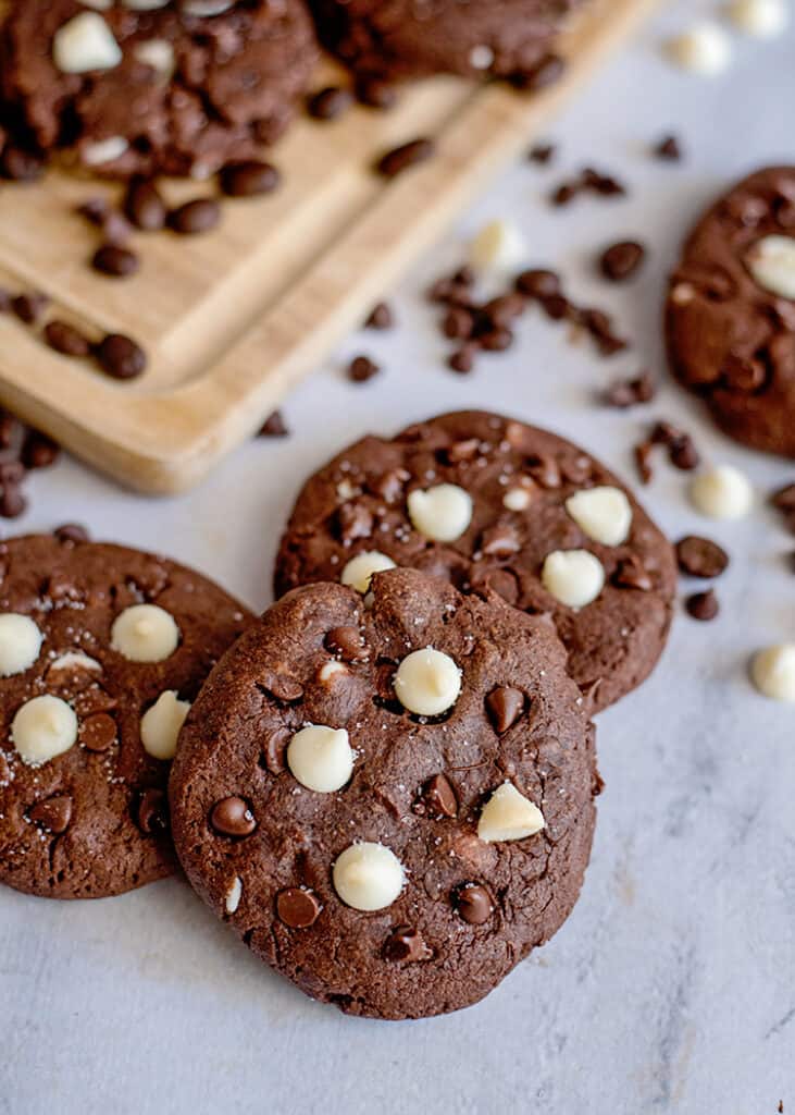 cookies on a marble surface with chocolate chips around them
